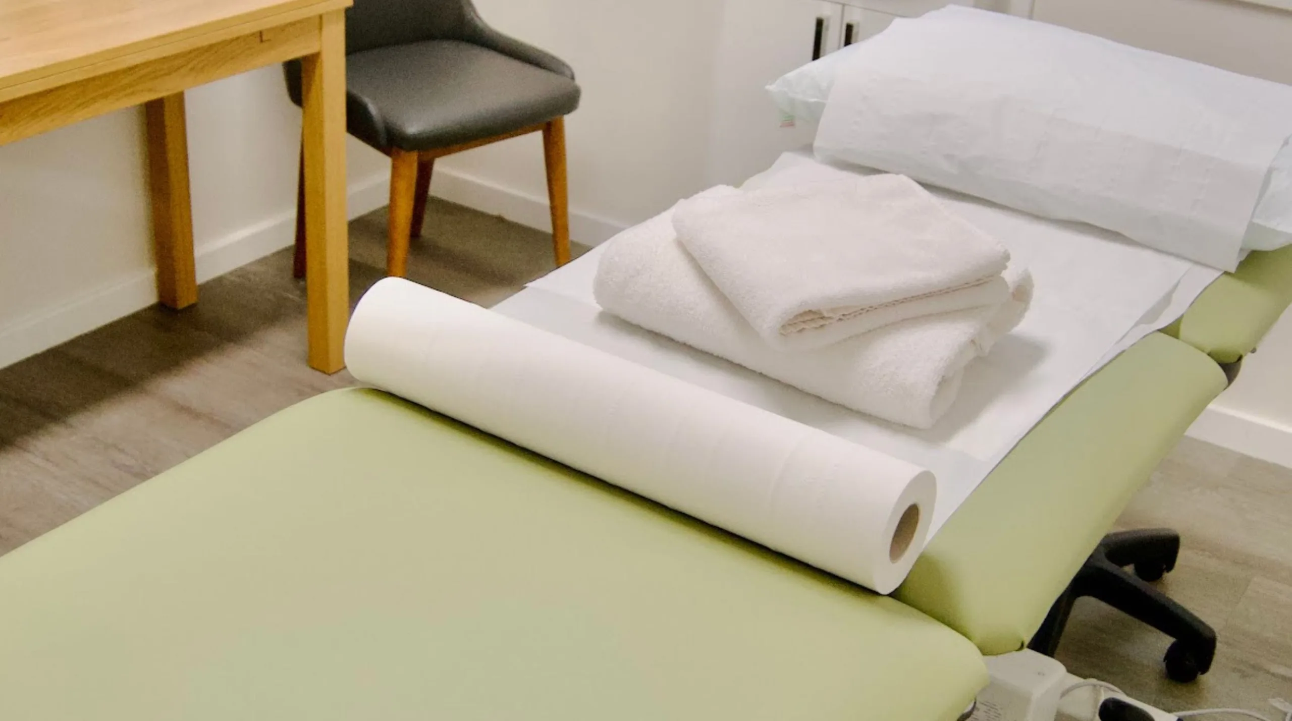 A clean and professional therapy bed.